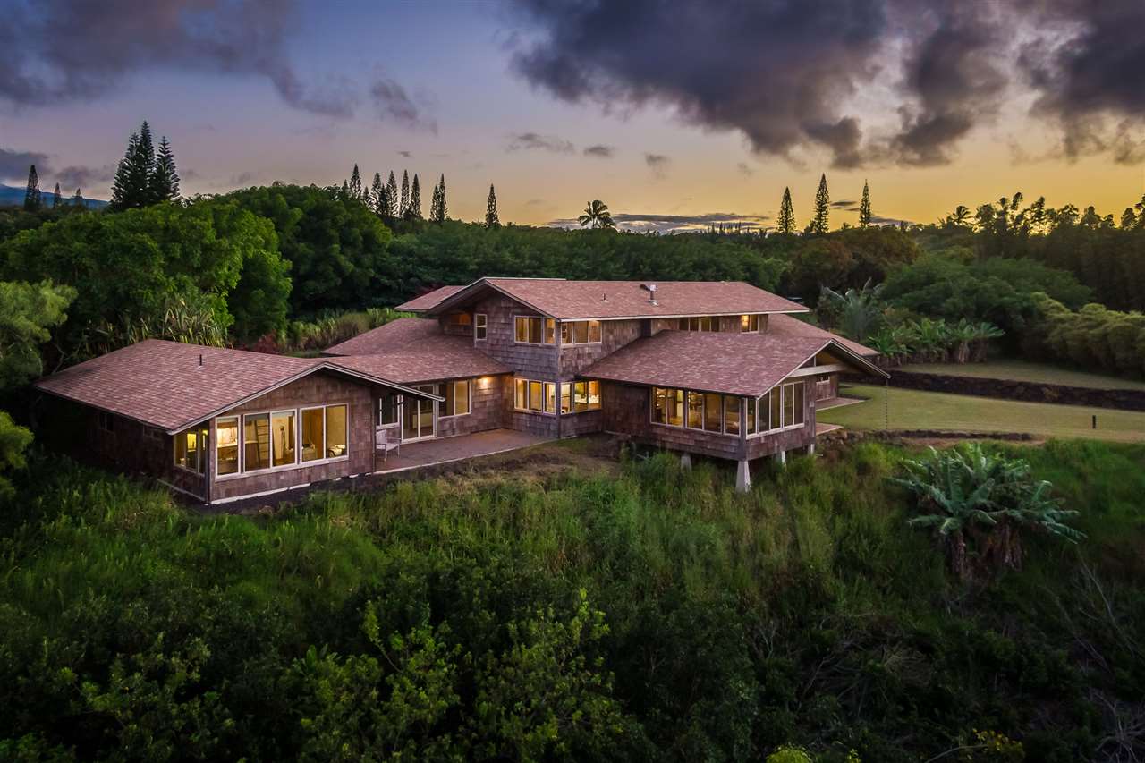 770 North Honokala Road, Unit A Haiku, HI 96708 - Photo 3 of 30 a view of a big house with a big yard and large trees