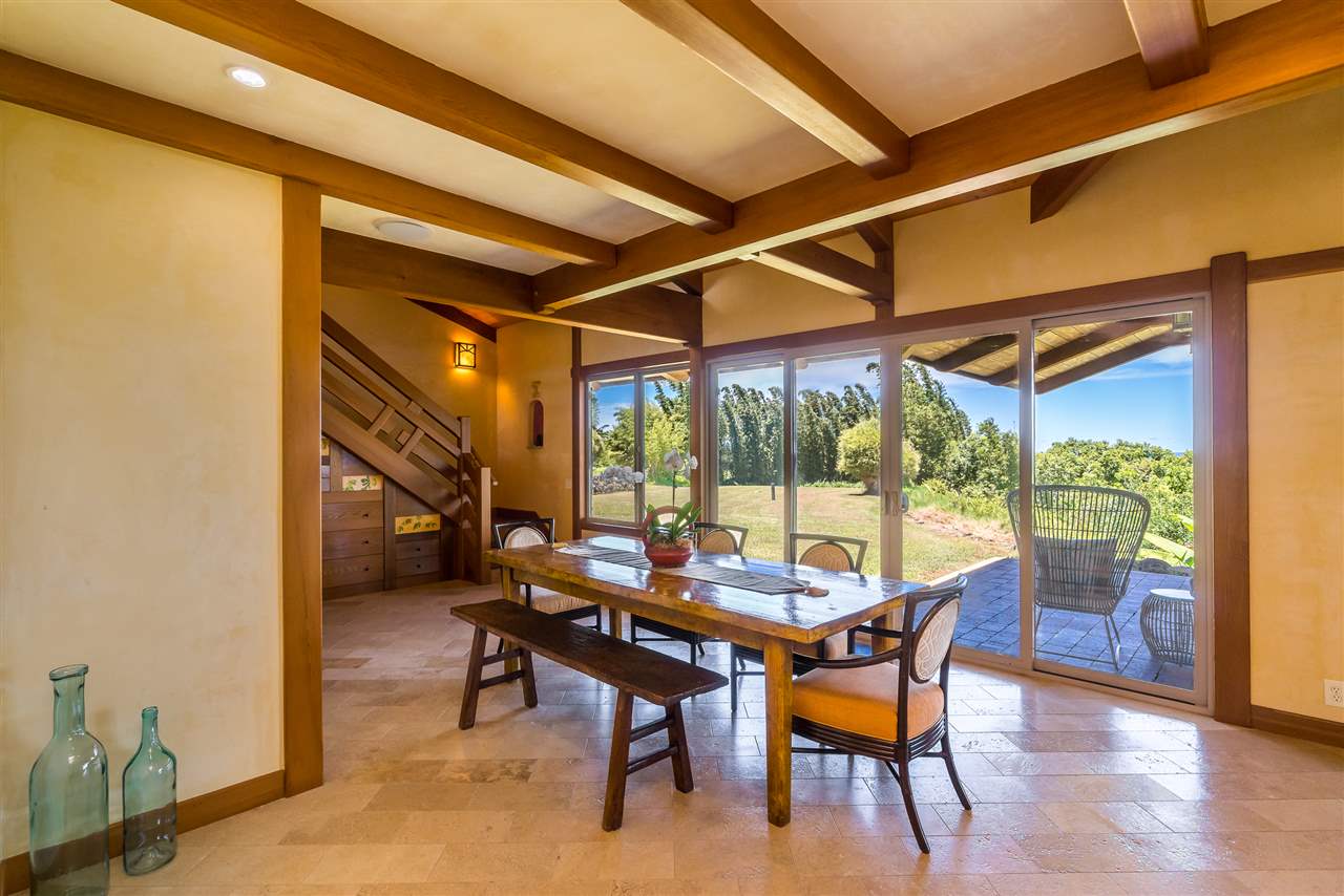 770 North Honokala Road, Unit A Haiku, HI 96708 - Photo 6 of 30 a dining room with furniture and wooden floor