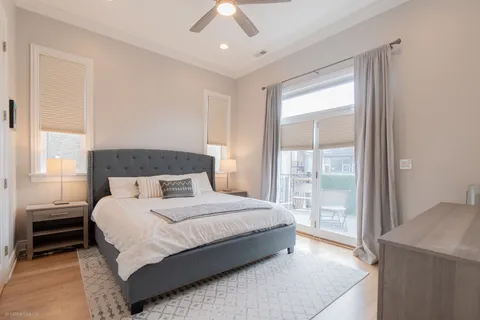 a bedroom with a bed and wooden floor