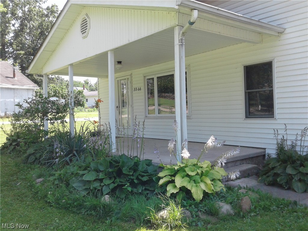 5566 Linn Road Amherst, OH 44001 - Photo 4 of 32 Beautiful flowers by the porch.