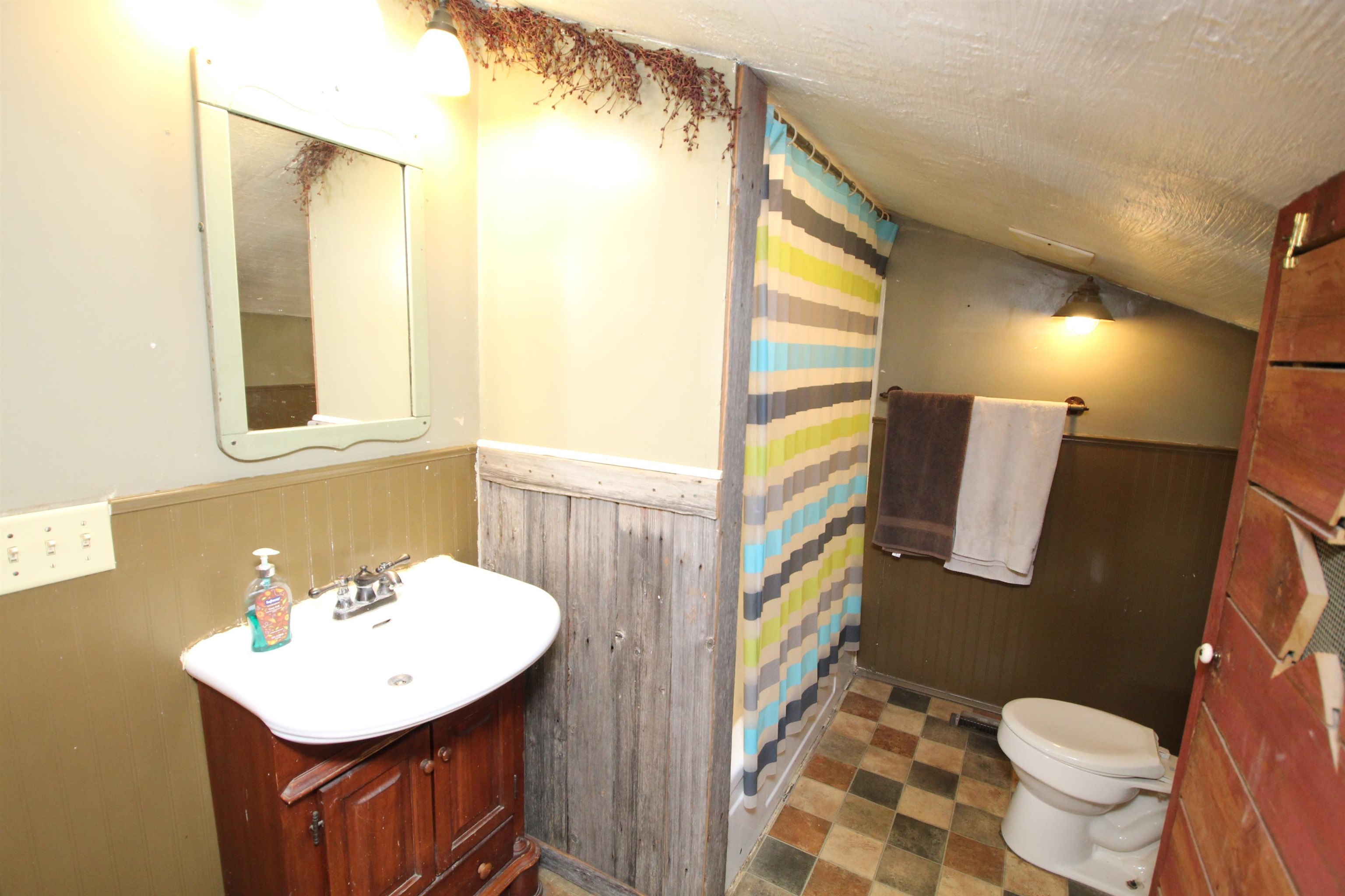 15210 Murphy Road Winnebago, IL 61088 - Photo 12 of 22 a bathroom with a sink a toilet a mirror and vanity