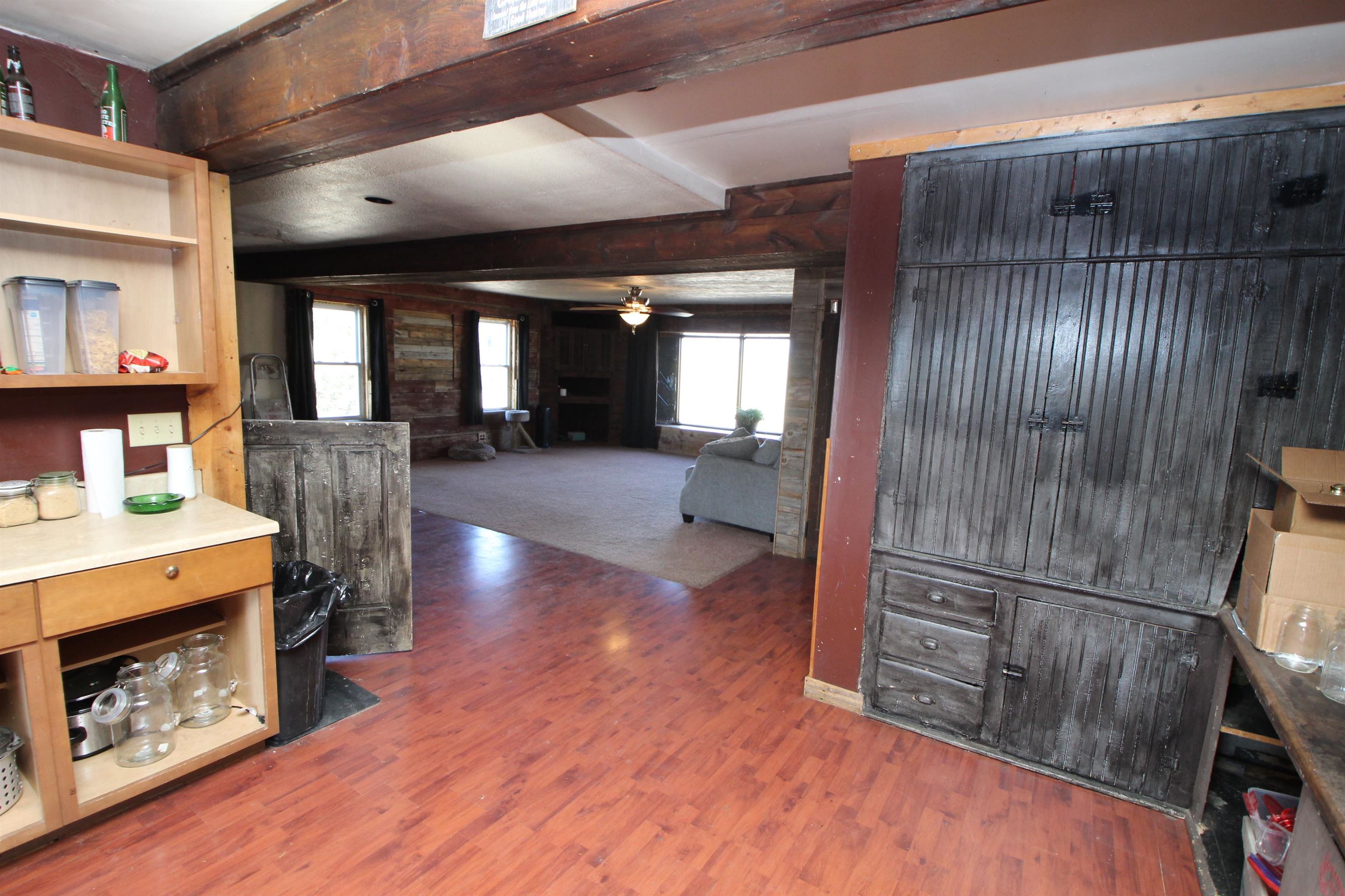 15210 Murphy Road Winnebago, IL 61088 - Photo 13 of 22 a view of a livingroom with furniture wooden floor fire place and an entrance