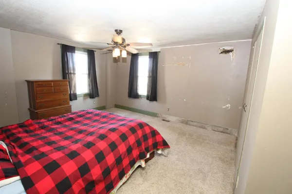 a bedroom with a large bed and a chandelier