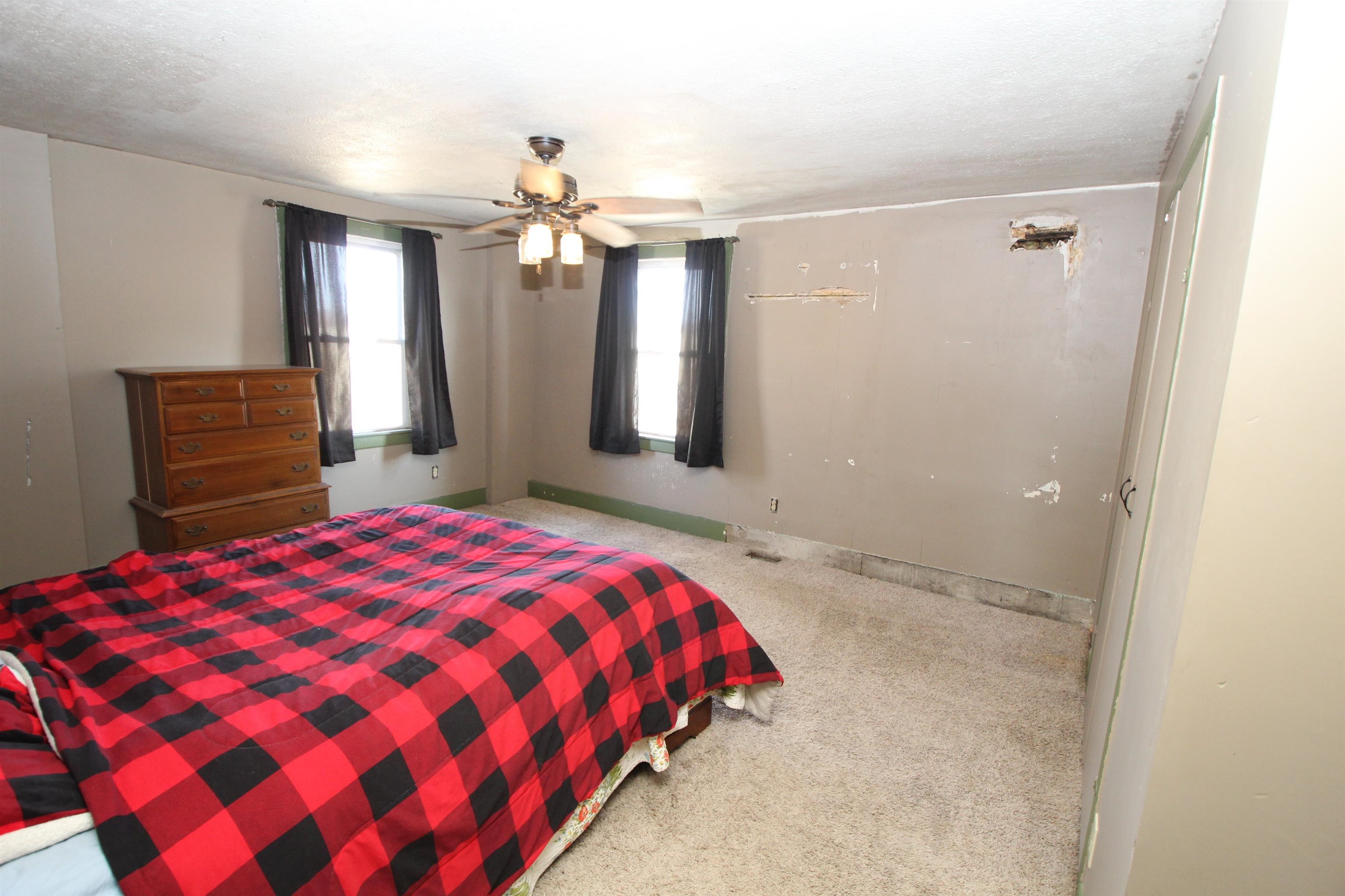 15210 Murphy Road Winnebago, IL 61088 - Photo 18 of 22 a bedroom with a large bed and a chandelier