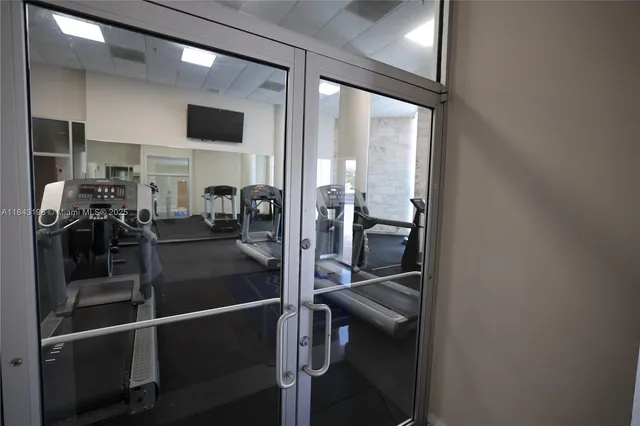 a view of a hallway with the view of living room and window