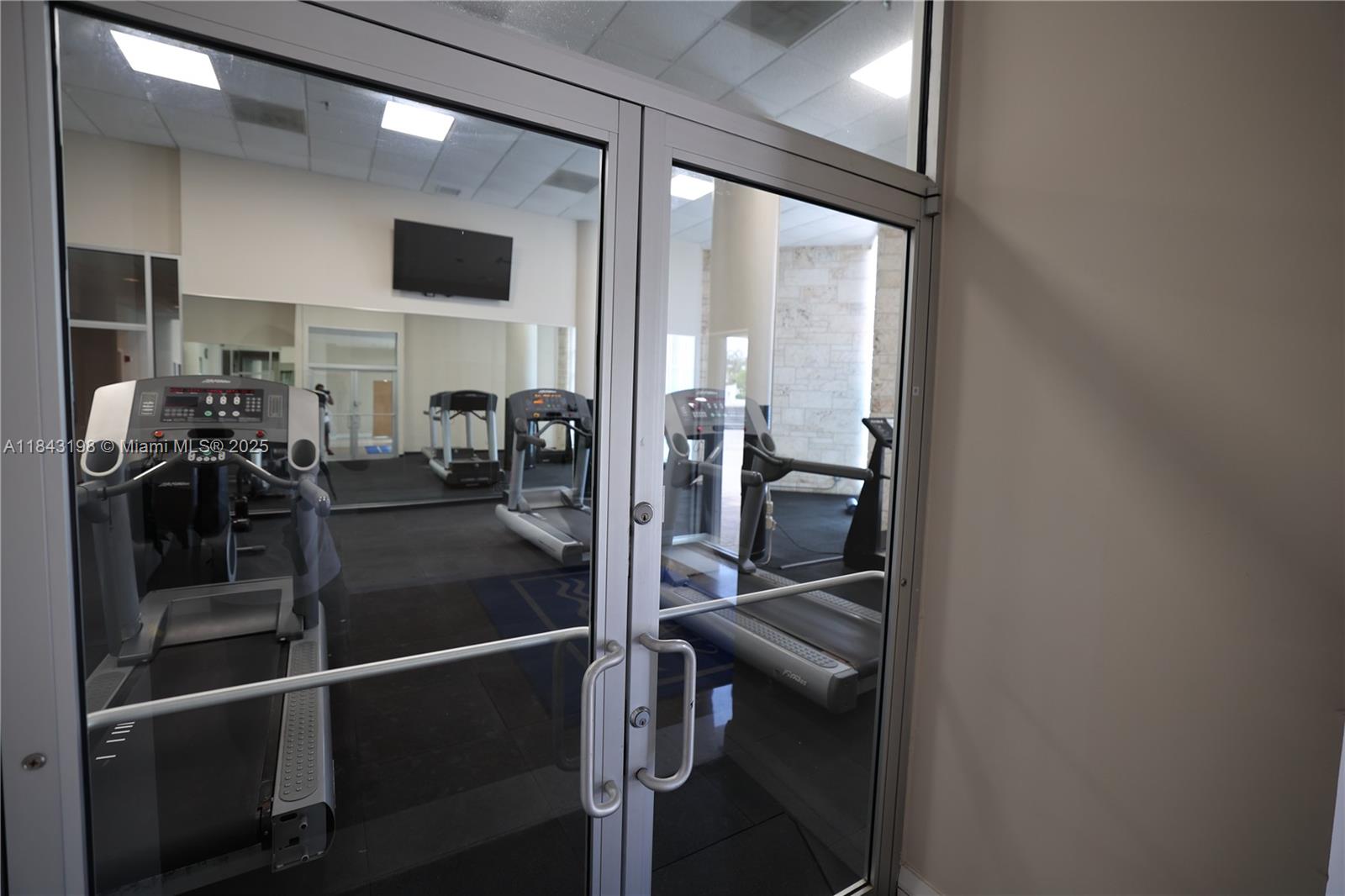 5151 Collins Avenue, Unit 927 Miami Beach, FL 33140 - Photo 15 of 19 a view of a hallway with the view of living room and window