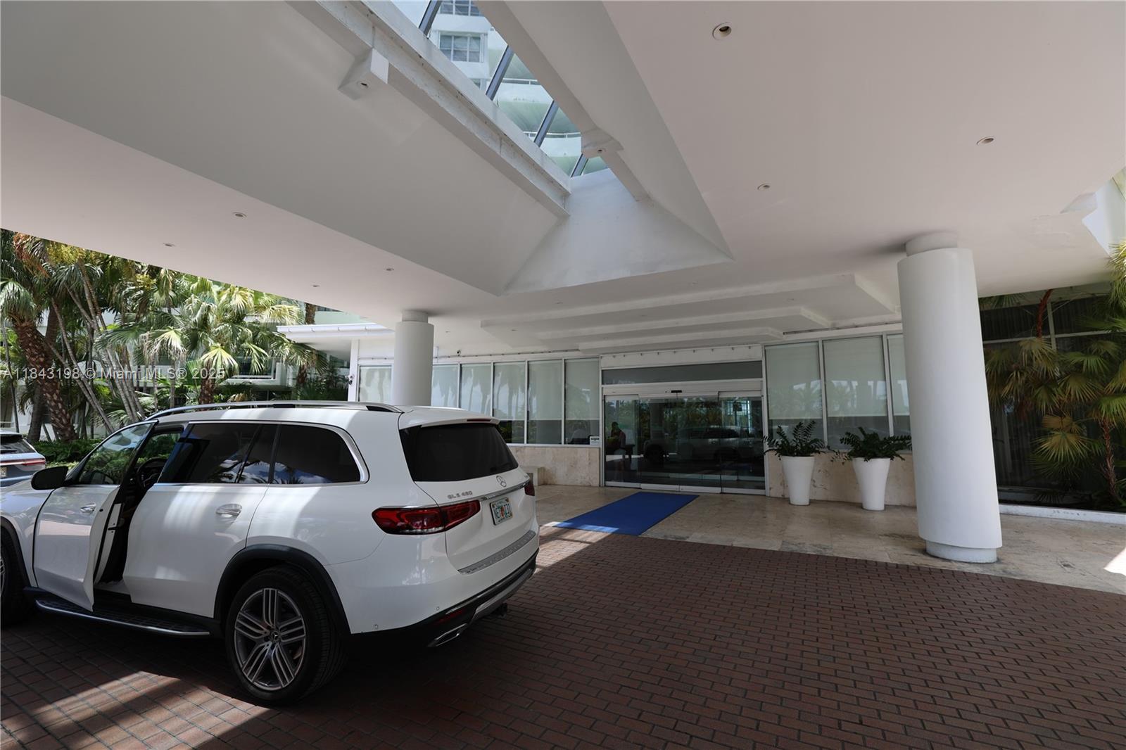 5151 Collins Avenue, Unit 927 Miami Beach, FL 33140 - Photo 18 of 19 a car parked in front of a building