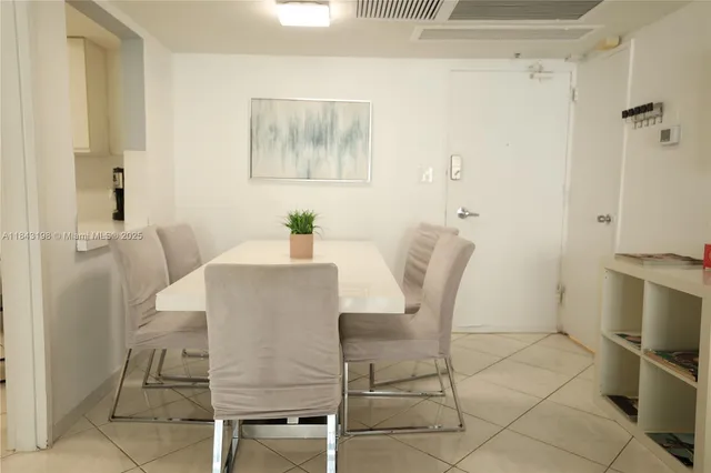 a view of a dining room with furniture and a chandelier