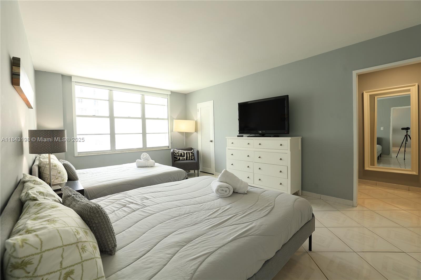 5151 Collins Avenue, Unit 927 Miami Beach, FL 33140 - Photo 7 of 19 a bedroom with a bed and a flat screen tv