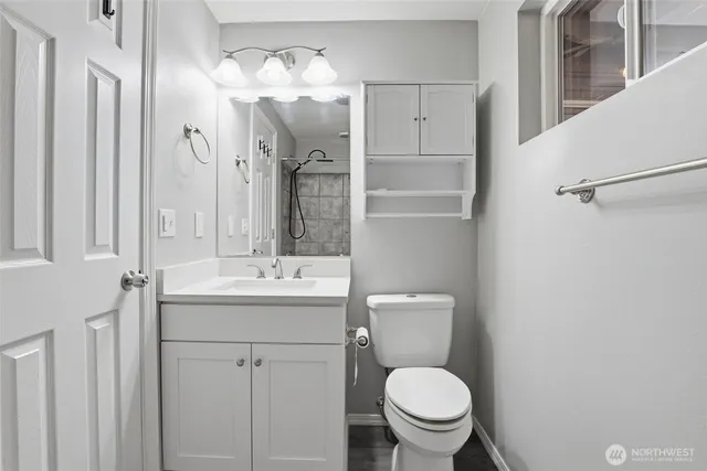 a bathroom with a toilet sink and mirror