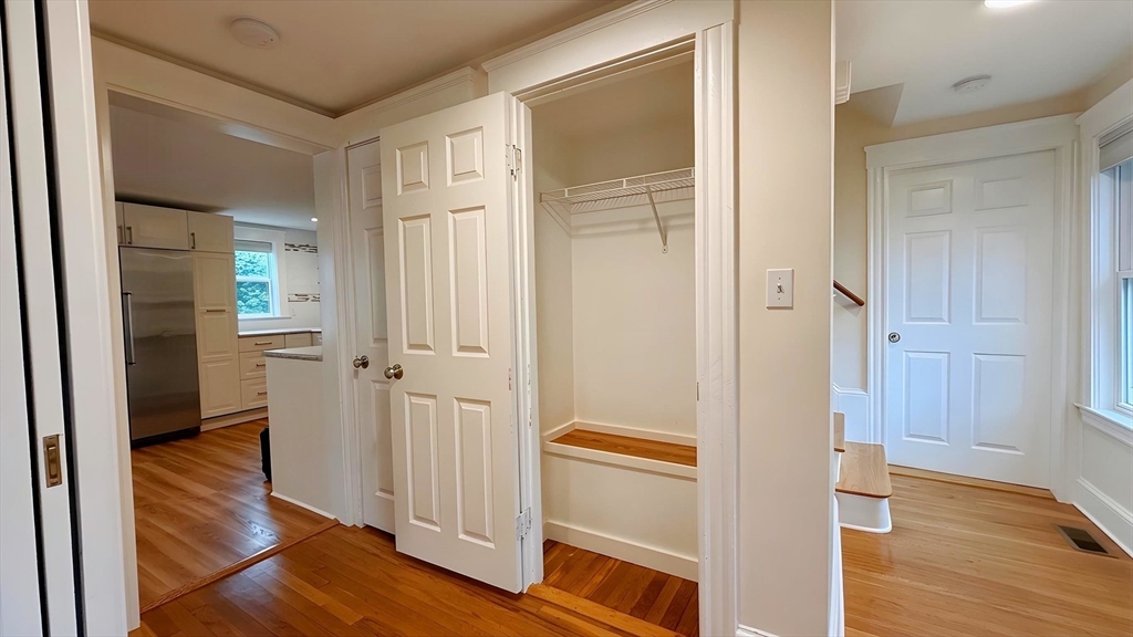 114 Curve Street Dedham, MA 02026 - Photo 15 of 27 a view of a bathroom with wooden floor and closet