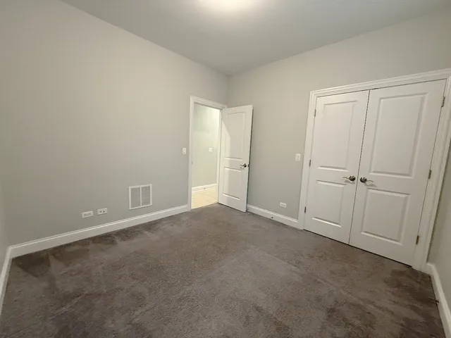 a view of an empty room and closet area