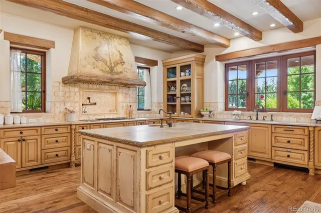 a kitchen with stainless steel appliances granite countertop a stove and cabinets