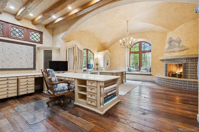 a living room with furniture a fireplace and a potted plant