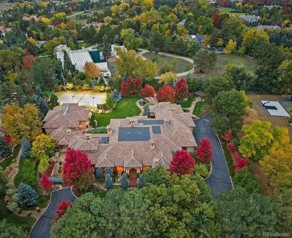 an aerial view of a house with a yard and lake view