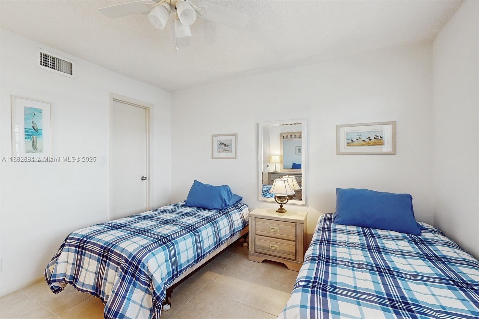 1501 South Ocean Boulevard, Unit 301 Lauderdale-by-the-Sea, FL 33062 - Photo 12 of 17 a bedroom with a bed and a lamp