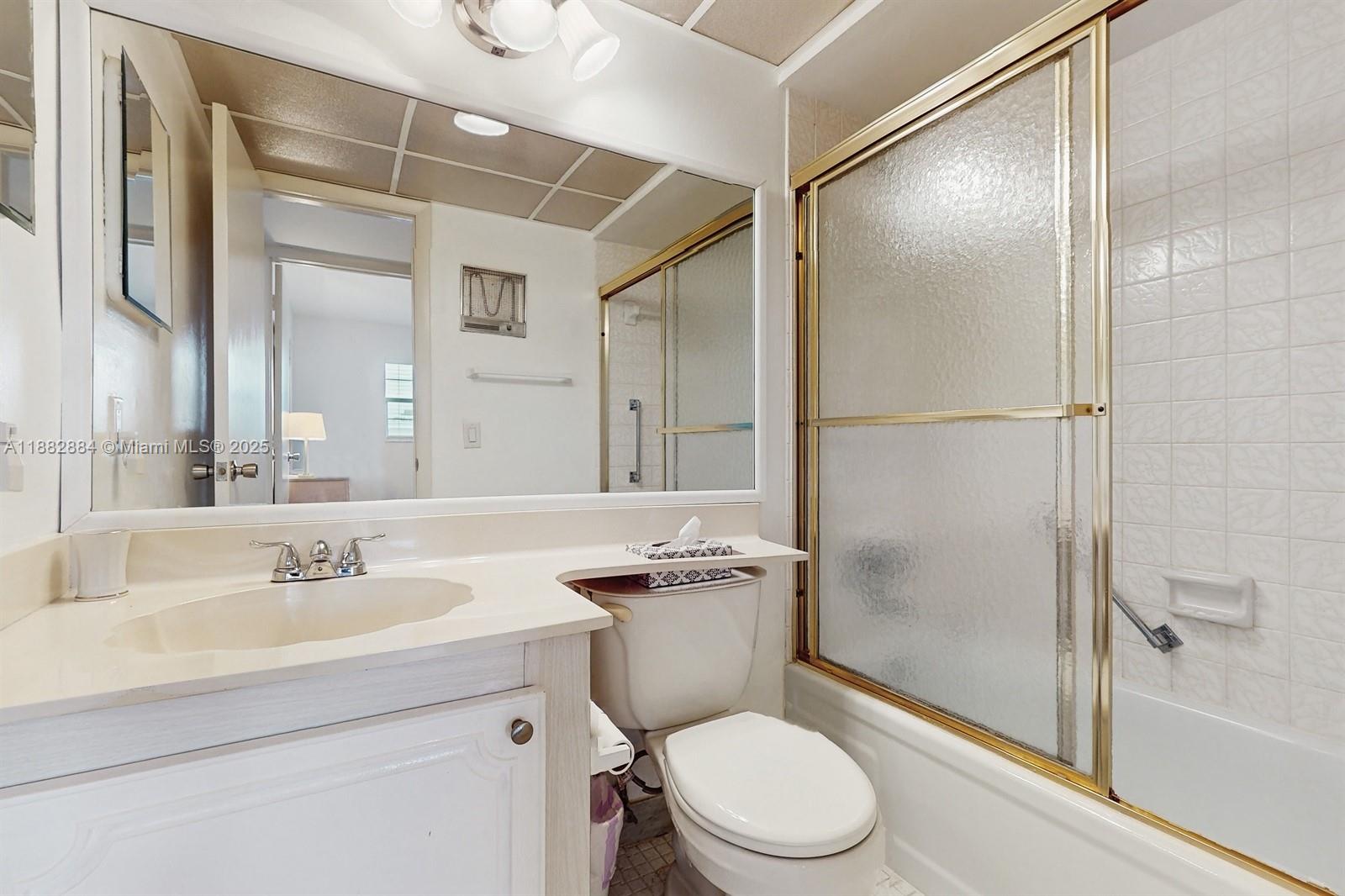 1501 South Ocean Boulevard, Unit 301 Lauderdale-by-the-Sea, FL 33062 - Photo 13 of 17 a bathroom with a sink toilet and shower
