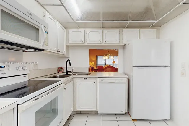 a kitchen with appliances a sink and cabinets