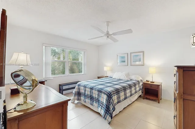 a bedroom with a bed table closet and a window