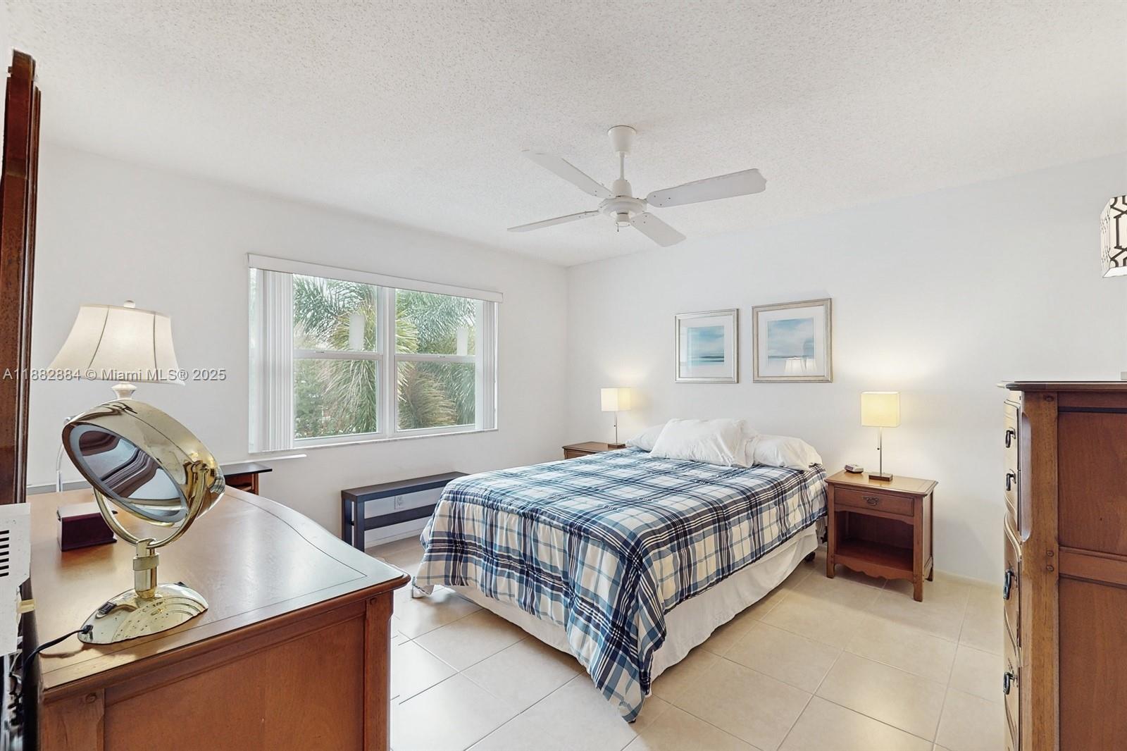 1501 South Ocean Boulevard, Unit 301 Lauderdale-by-the-Sea, FL 33062 - Photo 8 of 17 a bedroom with a bed table closet and a window