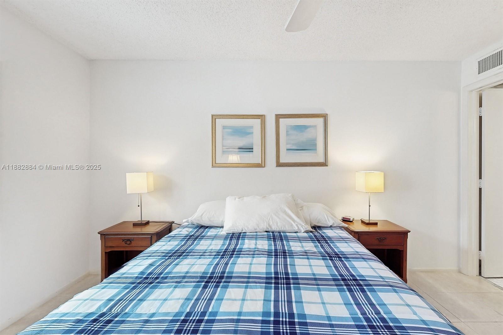 1501 South Ocean Boulevard, Unit 301 Lauderdale-by-the-Sea, FL 33062 - Photo 10 of 17 a bed room with a bed and a night stand