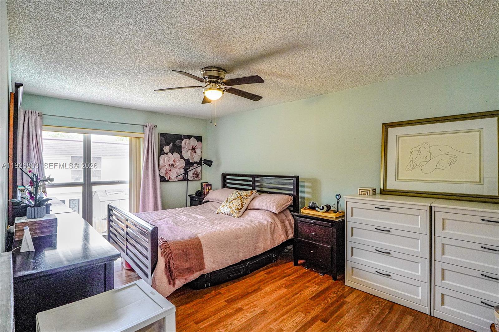 3331 Farragut Street, Unit 8A Hollywood, FL 33021 - Photo 11 of 26 a bedroom with a bed and wooden floor