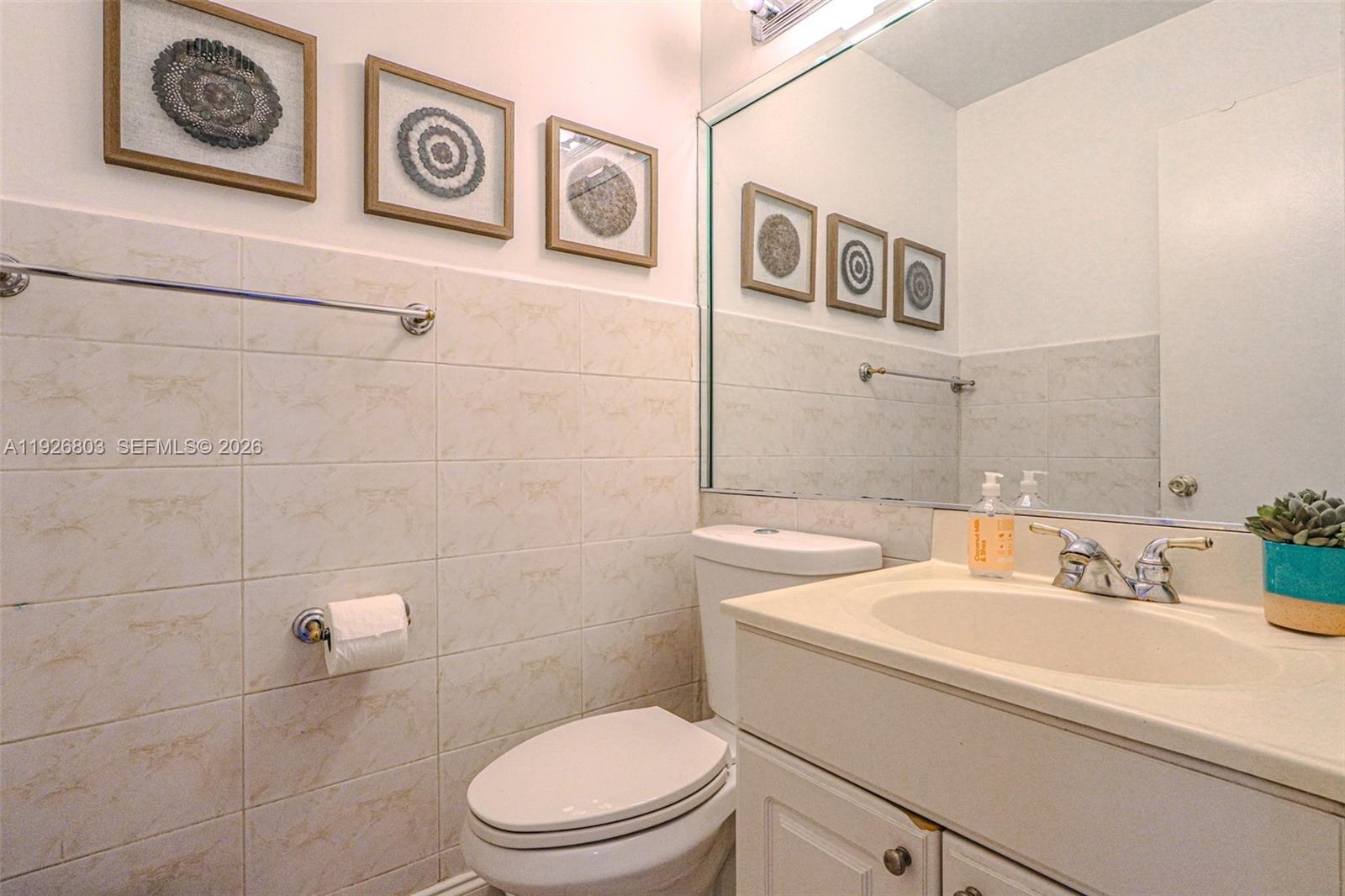 3331 Farragut Street, Unit 8A Hollywood, FL 33021 - Photo 14 of 26 a bathroom with a toilet a sink and mirror