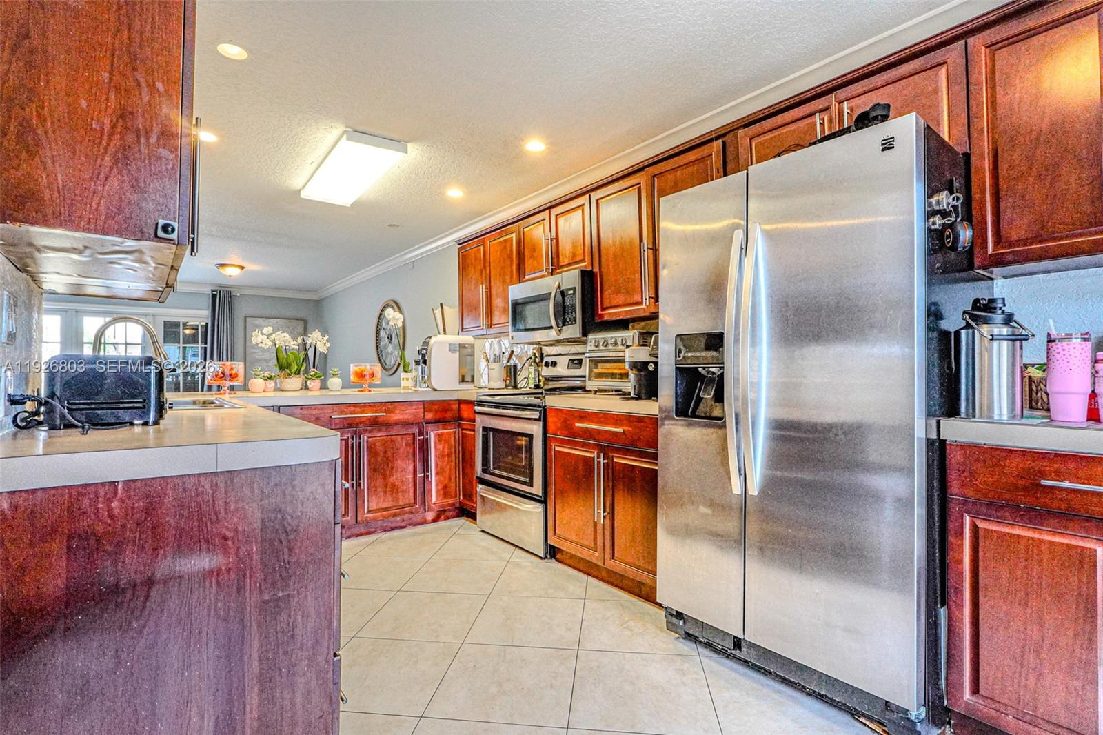 3331 Farragut Street, Unit 8A Hollywood, FL 33021 - Photo 19 of 26 a kitchen with stainless steel appliances granite countertop a refrigerator and a sink
