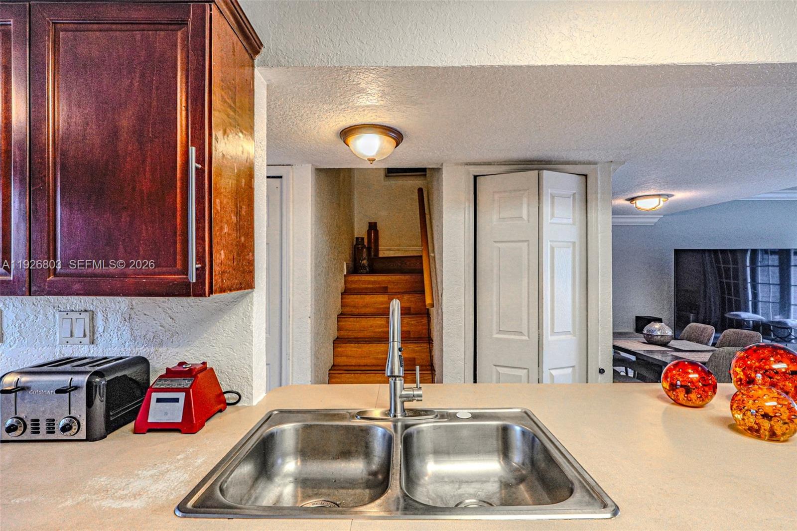 3331 Farragut Street, Unit 8A Hollywood, FL 33021 - Photo 20 of 26 a kitchen with blue cabinets a sink and a window