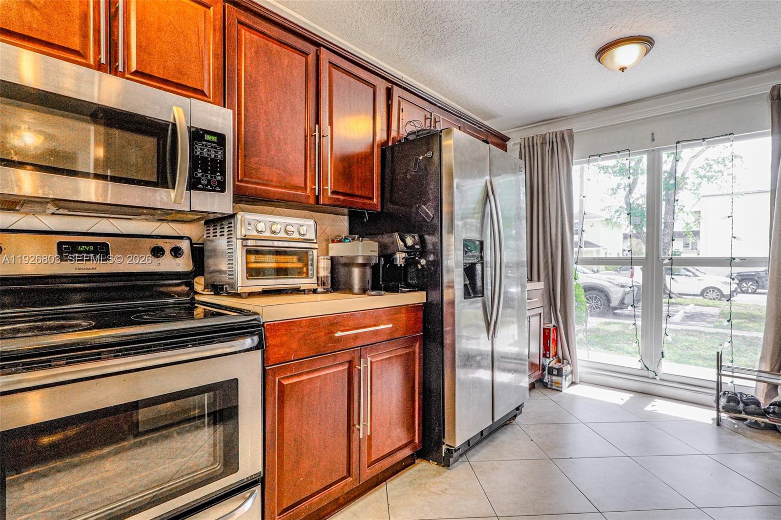 3331 Farragut Street, Unit 8A Hollywood, FL 33021 - Photo 2 of 26 a kitchen with stainless steel appliances granite countertop a refrigerator a stove and a sink with cabinets
