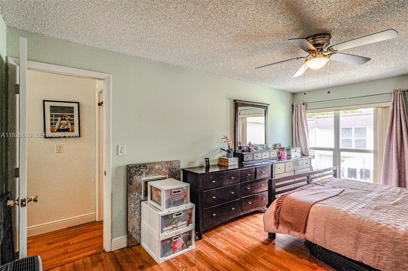 3331 Farragut Street, Unit 8A Hollywood, FL 33021 - Photo 10 of 26 a bedroom with a bed and wooden floor