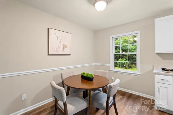 a view of a dining room with furniture and a window