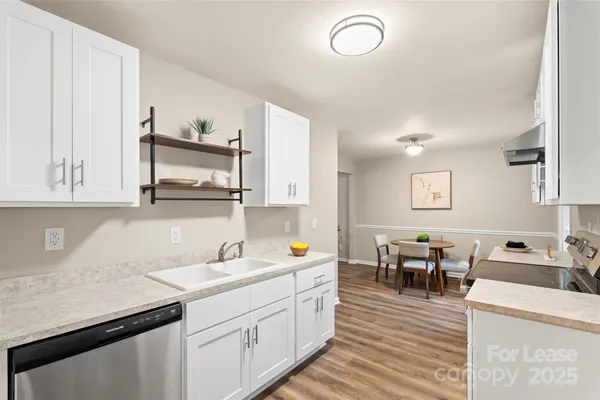a kitchen with sink and cabinets