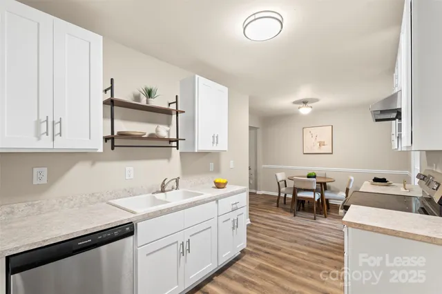 a kitchen with sink and cabinets