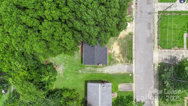 an aerial view of a house with a yard