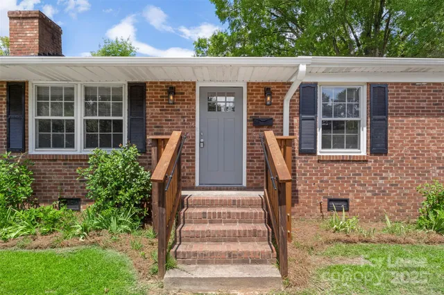 a front view of a house with large windows