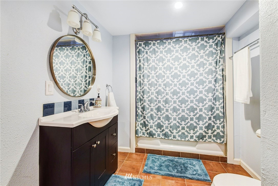 527 240th Street Southwest Bothell, WA 98021 - Photo 23 of 32 a bathroom with a sink a toilet and a mirror