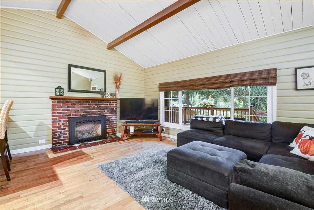 527 240th Street Southwest Bothell, WA 98021 - Photo 5 of 32 a living room with furniture a fireplace and floor to ceiling window