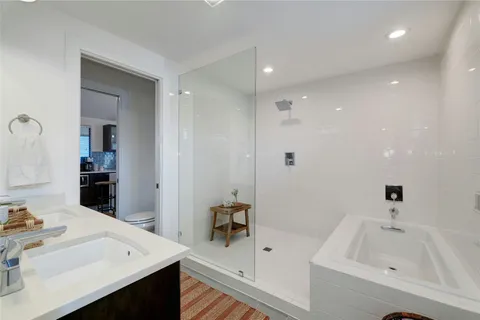 a bathroom with a bathtub sink and mirror