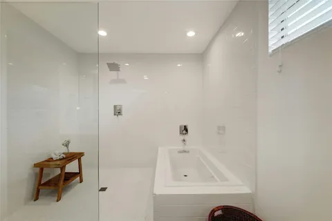 a bathroom with a tub and a sink