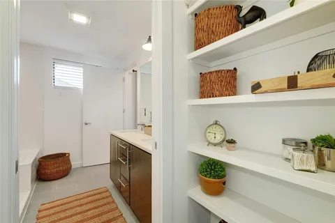 a bathroom with a double vanity sink and a mirror