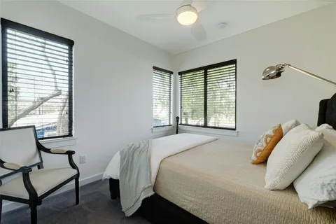 a bathroom with a double vanity sink a toilet and shower