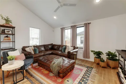 a living room with furniture and a potted plant