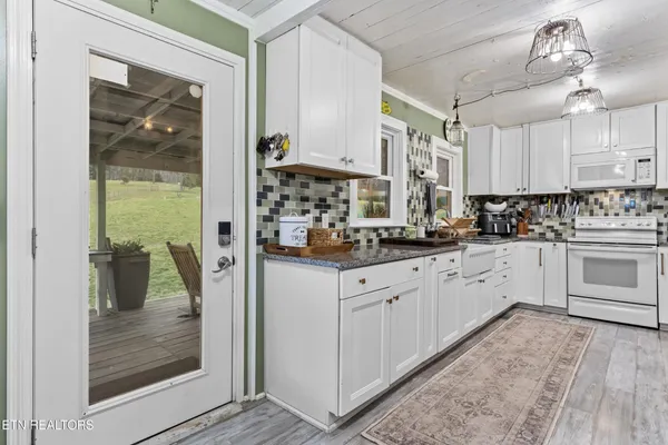 a kitchen with cabinets and window