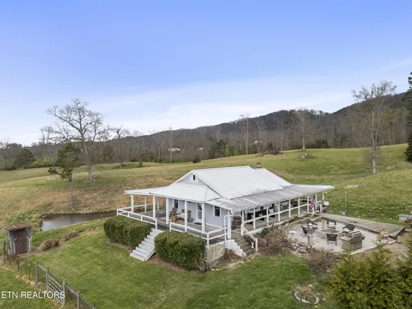 a view of a house with a yard and a lake view