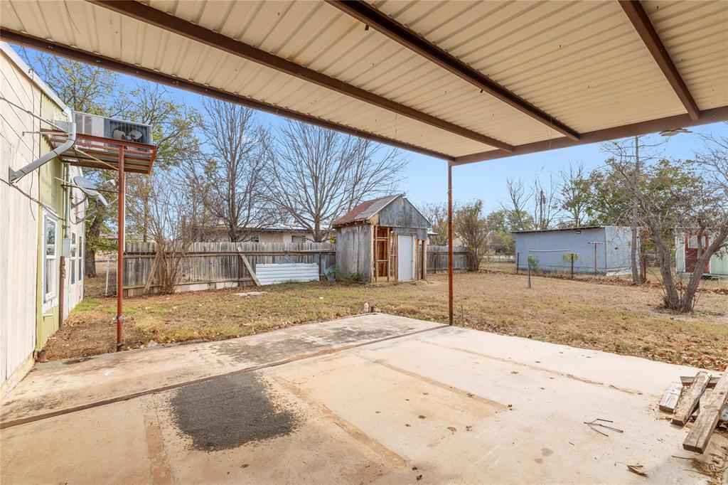 309 Goodwin Street Bangs, TX 76823 - Photo 18 of 20 Fenced backyard with a patio area and a shed