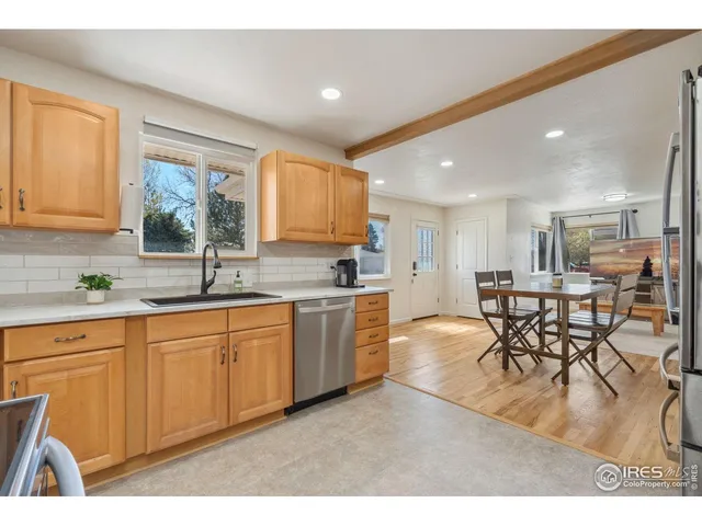 a kitchen with a table chairs sink and cabinets