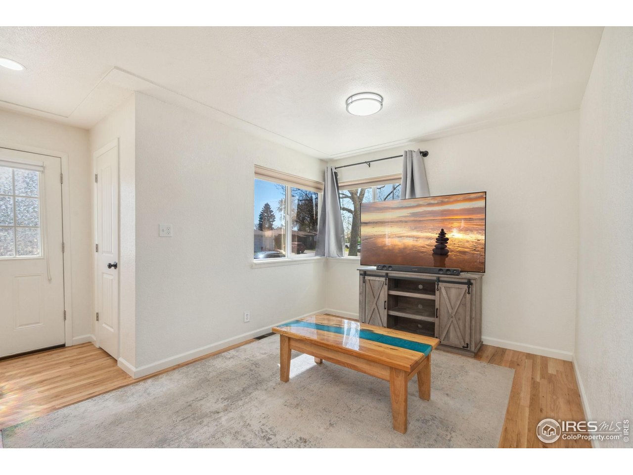 113 Balsam Street Fort Morgan, CO 80701 - Photo 10 of 30 a living room with furniture and a wooden floor