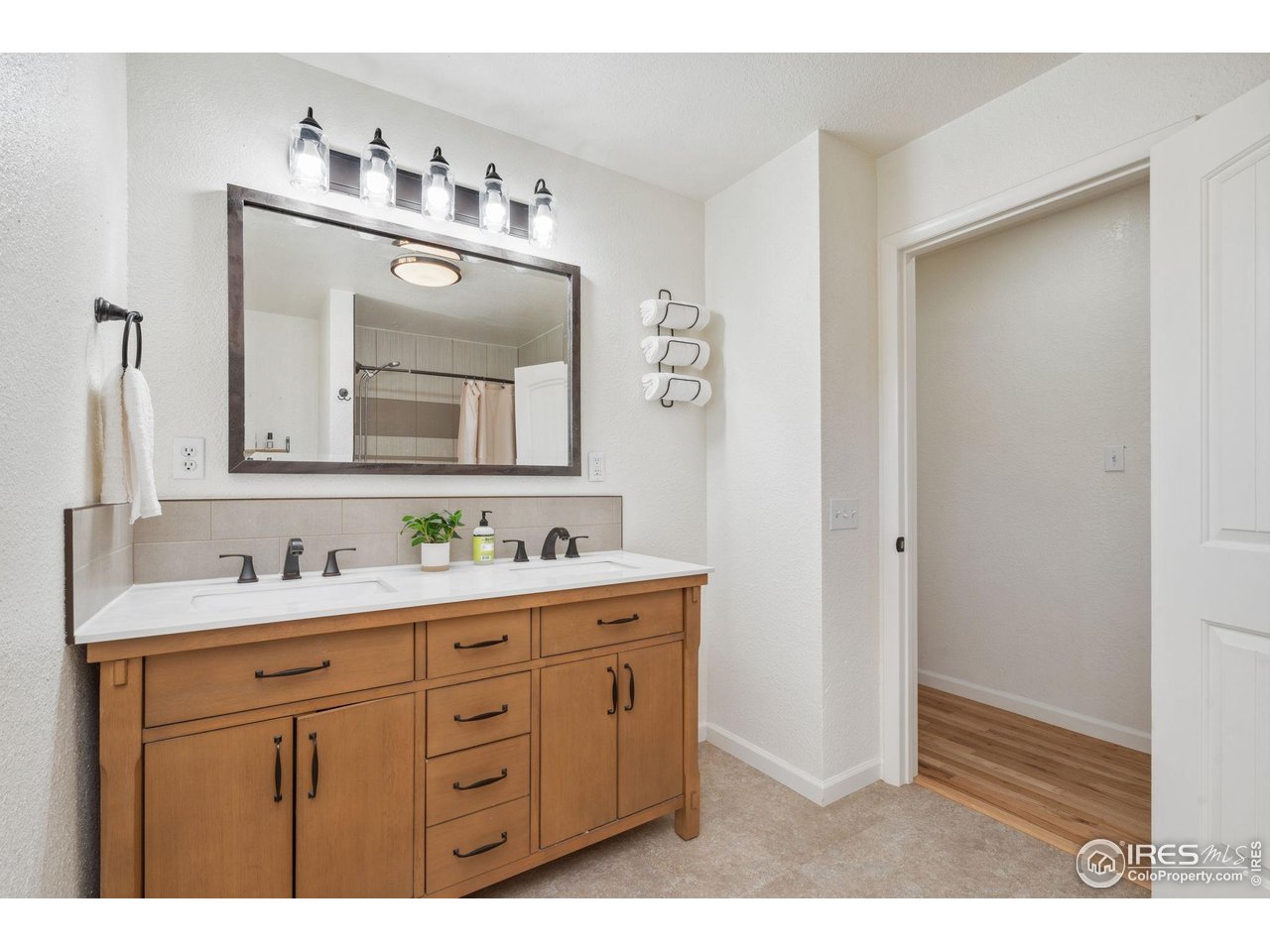 113 Balsam Street Fort Morgan, CO 80701 - Photo 14 of 30 a bathroom with a double vanity sink and mirror