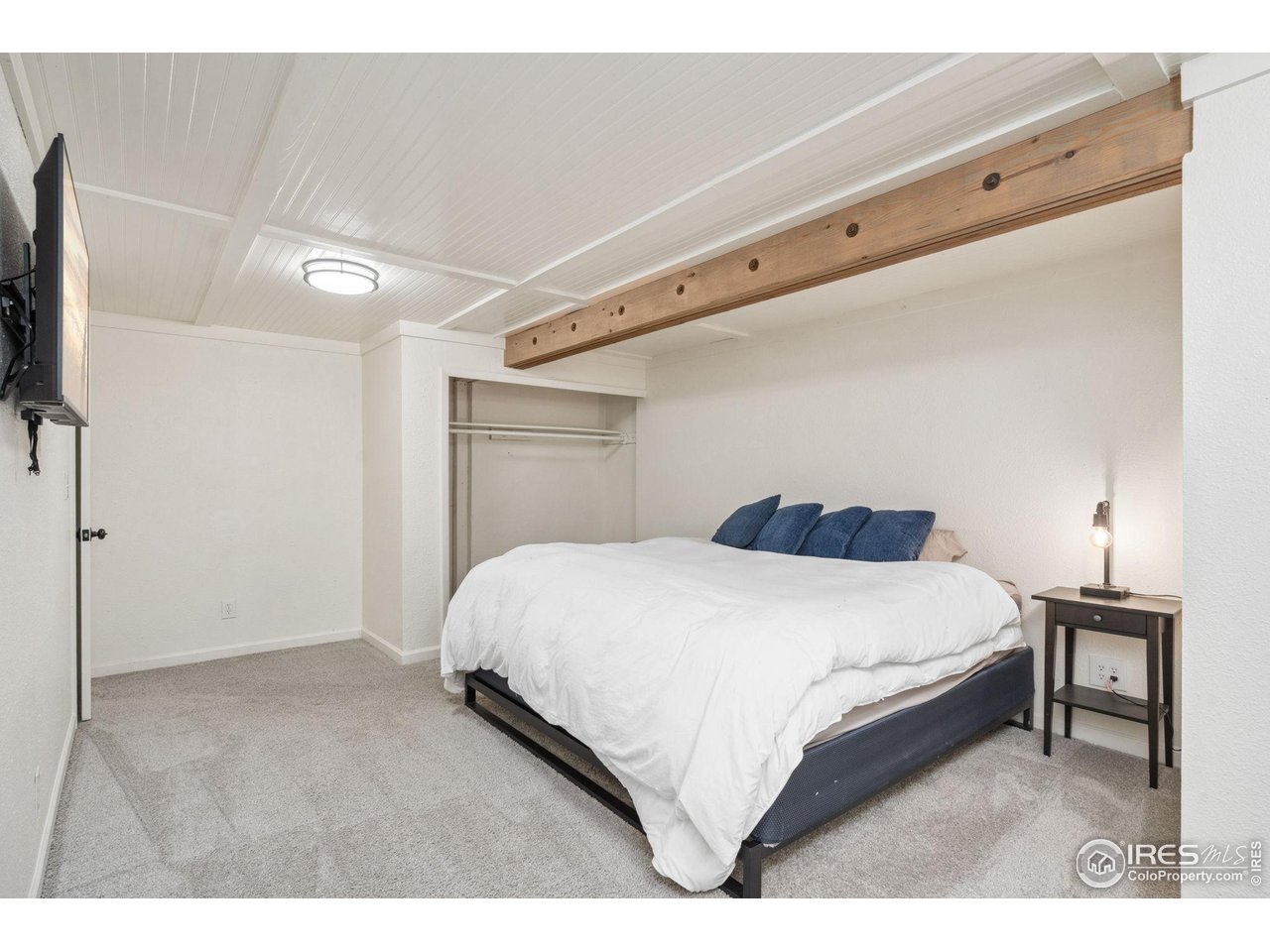 113 Balsam Street Fort Morgan, CO 80701 - Photo 18 of 30 a bedroom with a bed and a flat screen tv